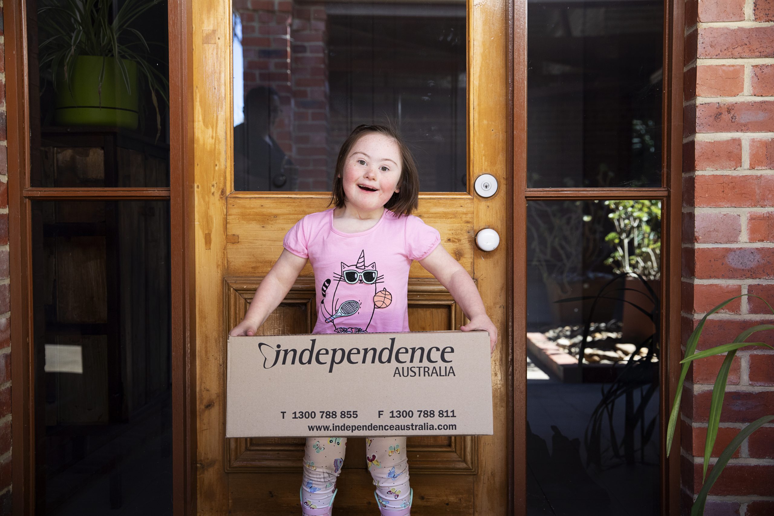 Little girl holding Independence Australia delivery box