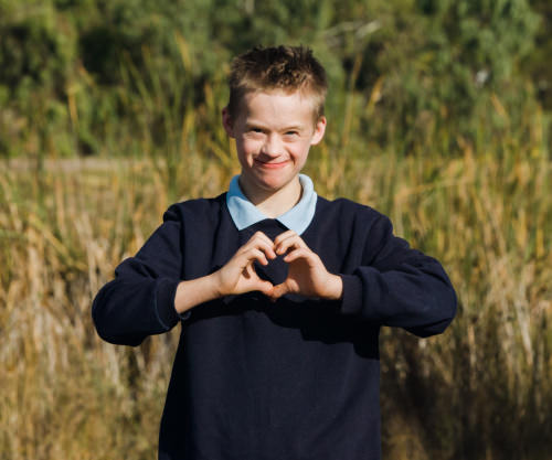 Boy holding hands as love heart