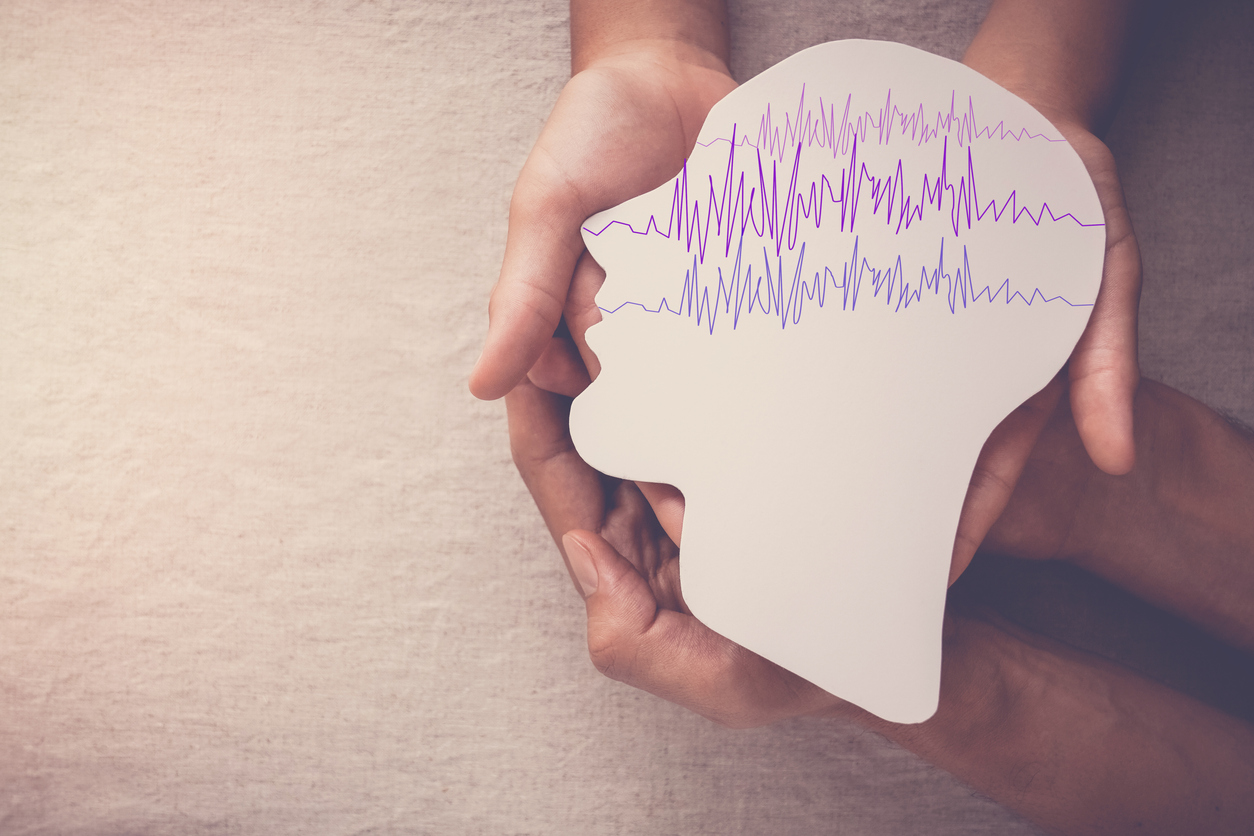 Adult and child hands holding encephalography brain paper cutout, Epilepsy awareness, seizure disorder, mental health concept epilepsy brain activity