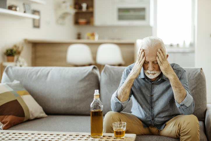 Senior Man Drinking Alcohol at Home Senior man drinking alcohol image