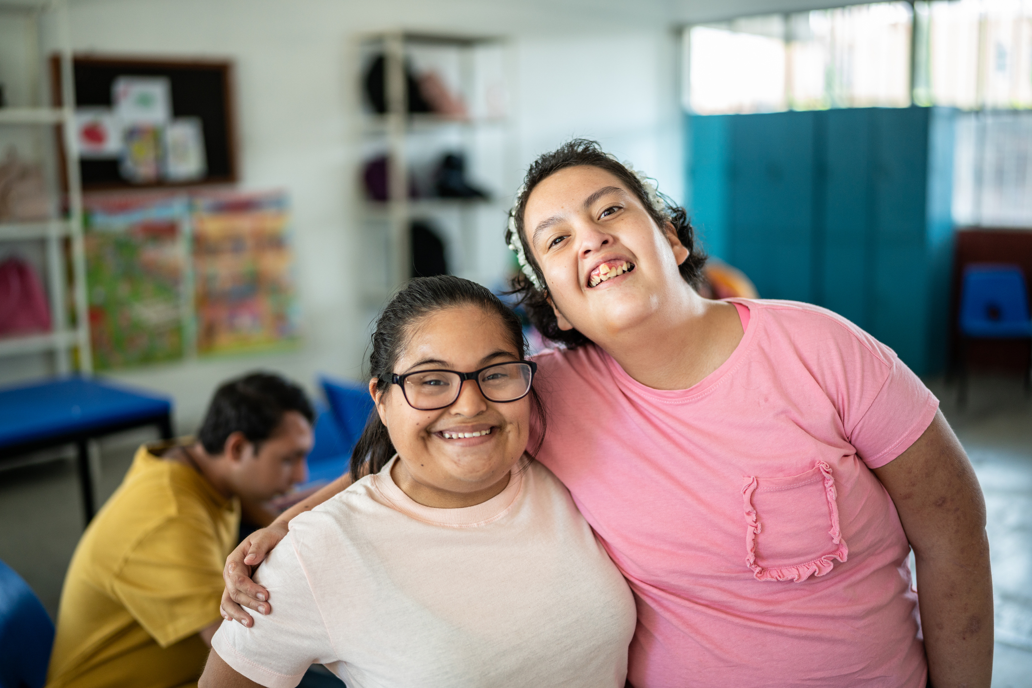 Portrait of disabled students embracing in the classroom