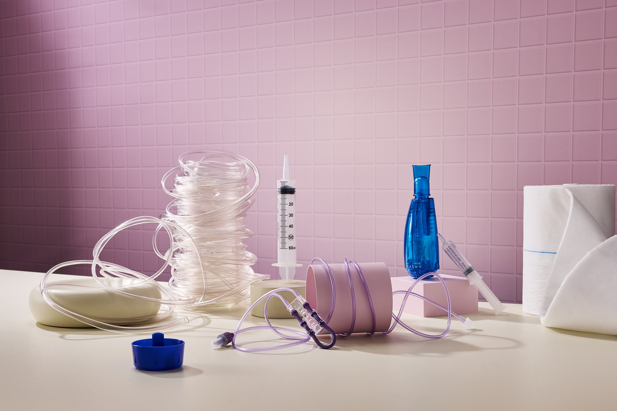Medical aids including tubing, syringes, specimen containers and clinical supplies on a countertop.